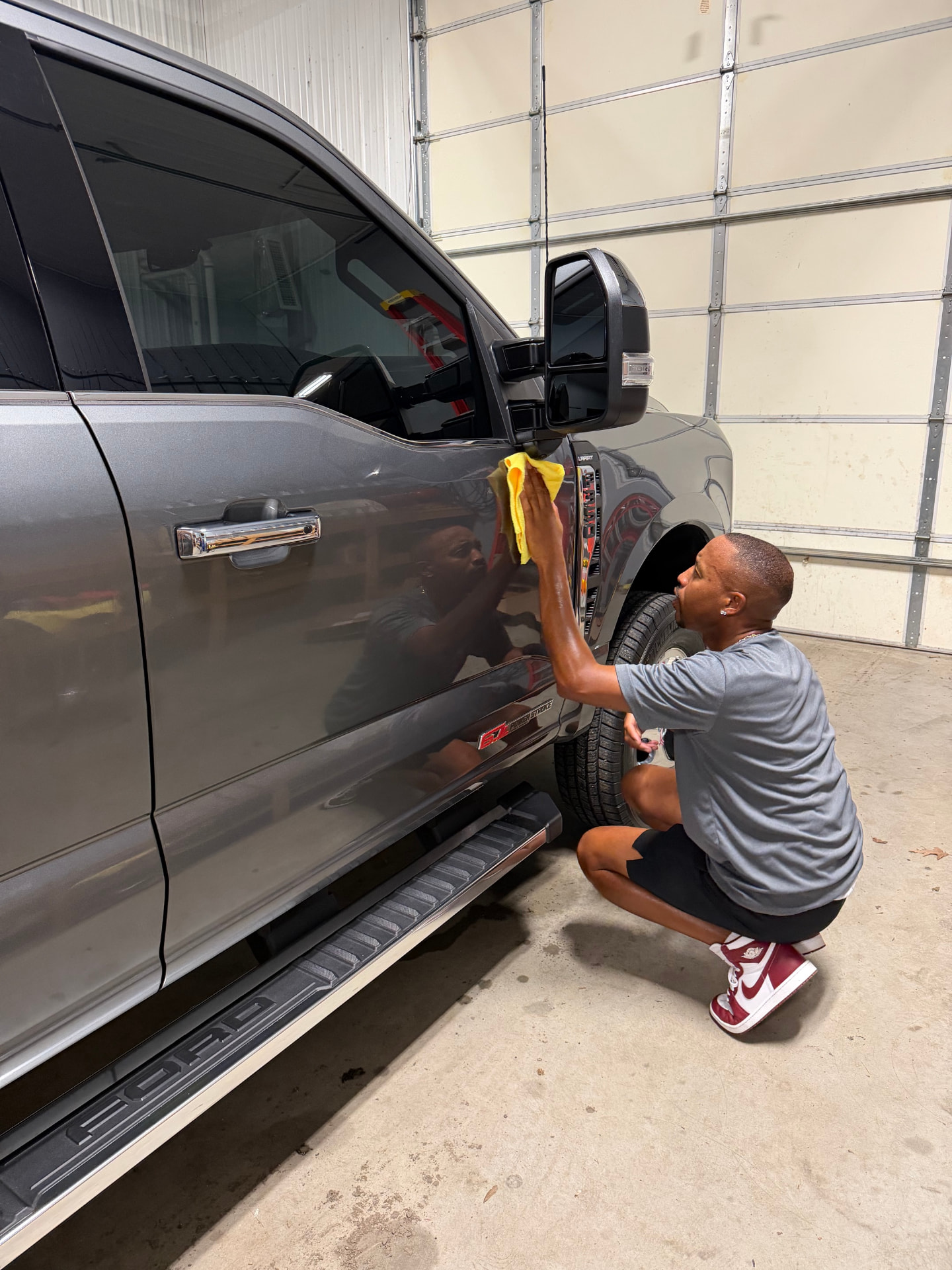 Apex technician hand-finishing a truck door during Ceramic Coating service