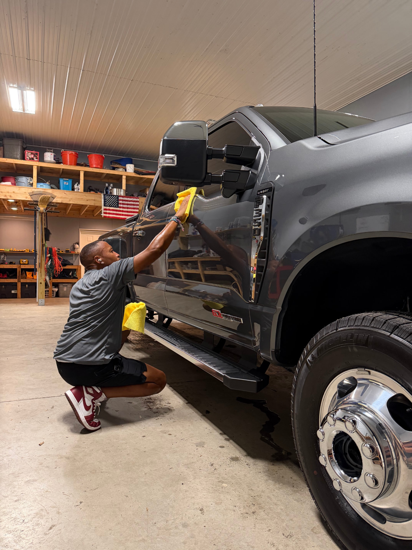 Apex technician wiping down a truck mirror to reveal the coated finish