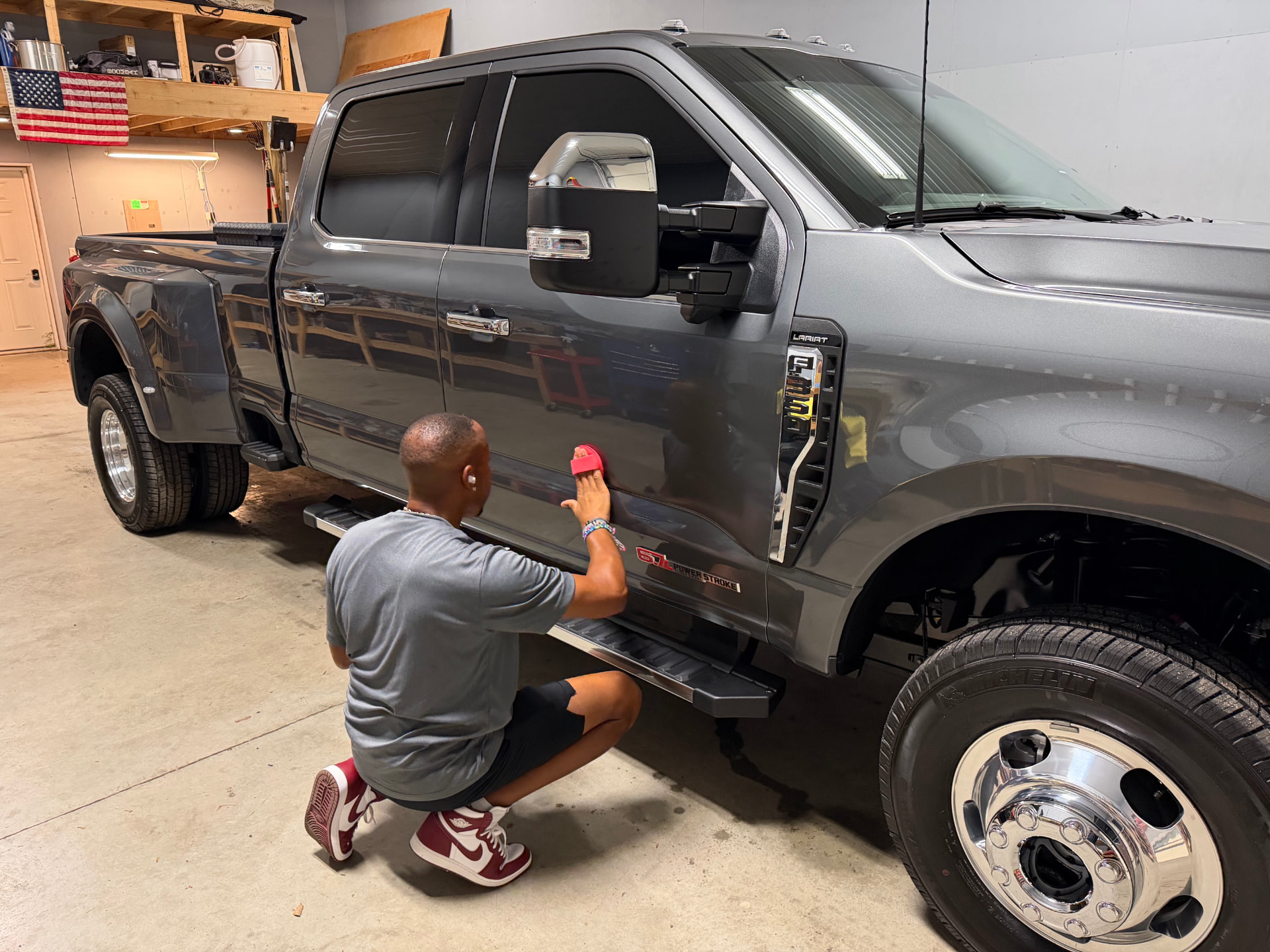 Apex technician hand-applying Ceramic Coating to a Ford truck